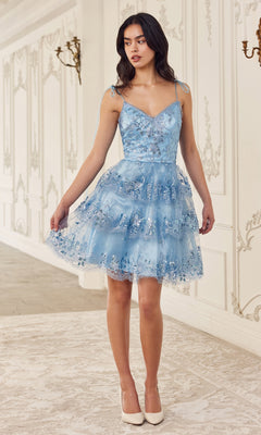 A woman in the Sequin-Print Short Ruffled Homecoming Dress KV1090 stands indoors on a patterned rug, paired with white heels.