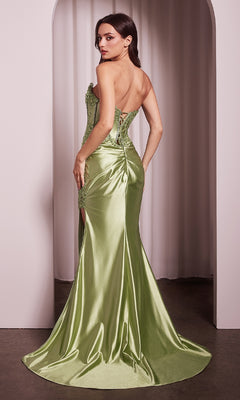 A woman stands under an archway facing away, wearing the Ladivine KV1116 Strapless Long Corset Prom Dress in light green, featuring a lace-up back, floor-length train, and beaded-lace appliqué.
