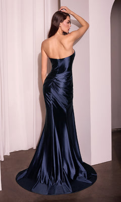 A woman in a dark blue Strapless Long Satin Prom Dress: Ladivine KV1118 stands with her back to the camera, one arm raised and touching her head.