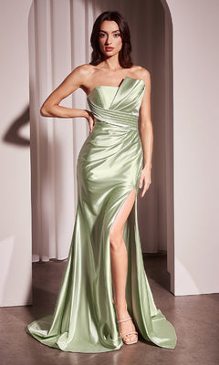 A woman stands before an archway wearing the Ladivine KV1118, a strapless long satin prom dress in light green with a thigh-high slit and ruched detailing, paired with beige high-heeled sandals.