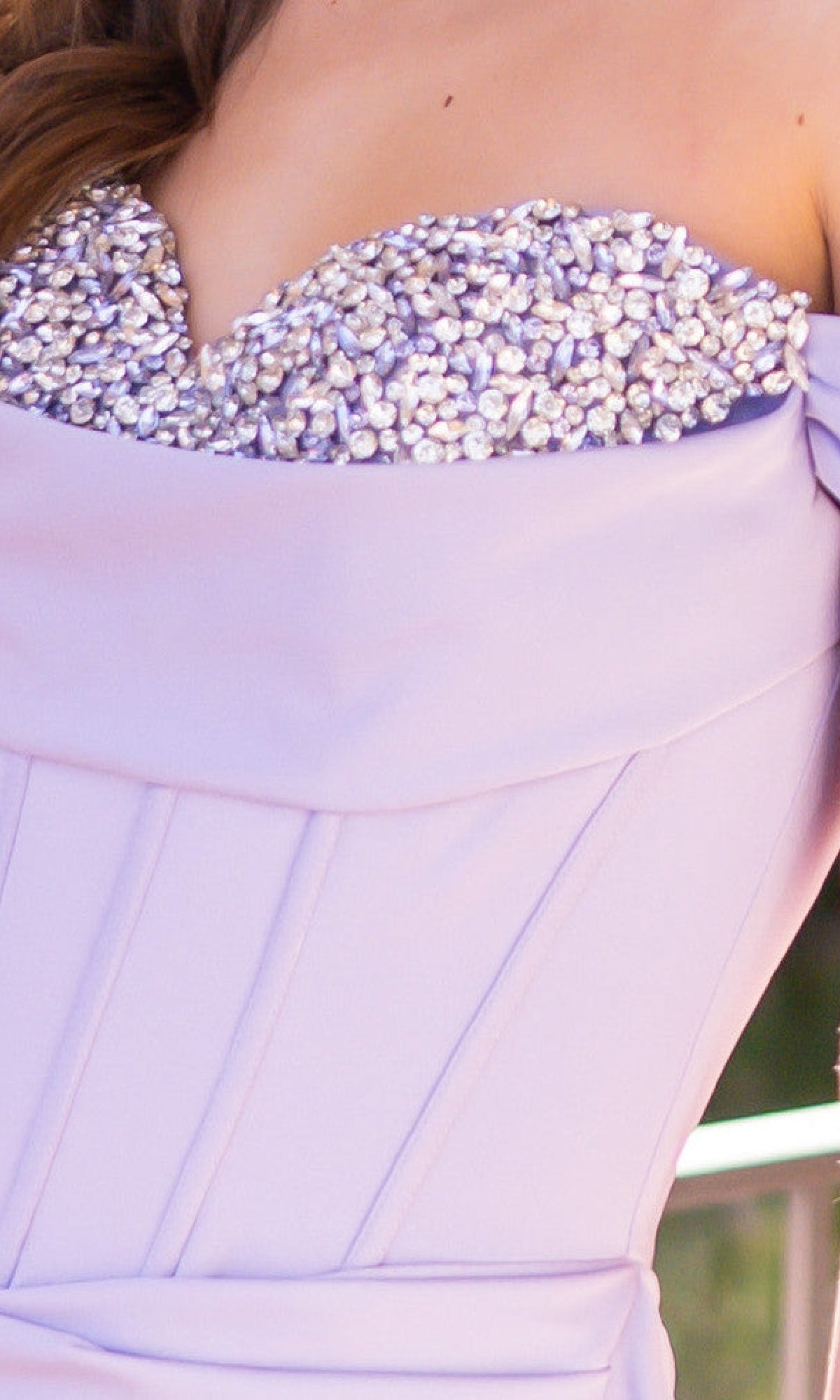 Close-up of the Off-the-Shoulder Corset Prom Dress: Katrina by Velvi in lavender, featuring pearl embellishments along the top edge and visible seam detailing.