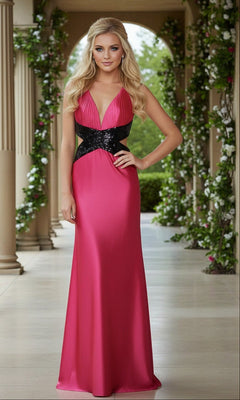 A woman wears the La Femme Open-Back Black-Strap Prom Dress 14660—a floor-length pink gown with a plunging v-neckline and black sequin waistband—standing in a columned, greenery-adorned outdoor walkway.