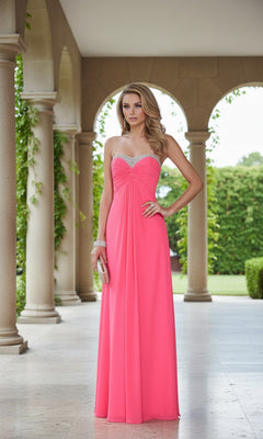 A woman stands in an outdoor colonnade wearing the La Femme 21461 long prom dress, a strapless, floor-length pink gown that flows elegantly with greenery in the background.