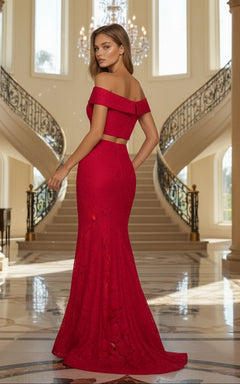 Woman in the La Femme Two-Piece Mermaid Lace Prom Dress 27443 stands on a marble floor before a grand staircase and chandelier in a spacious, elegant hall.