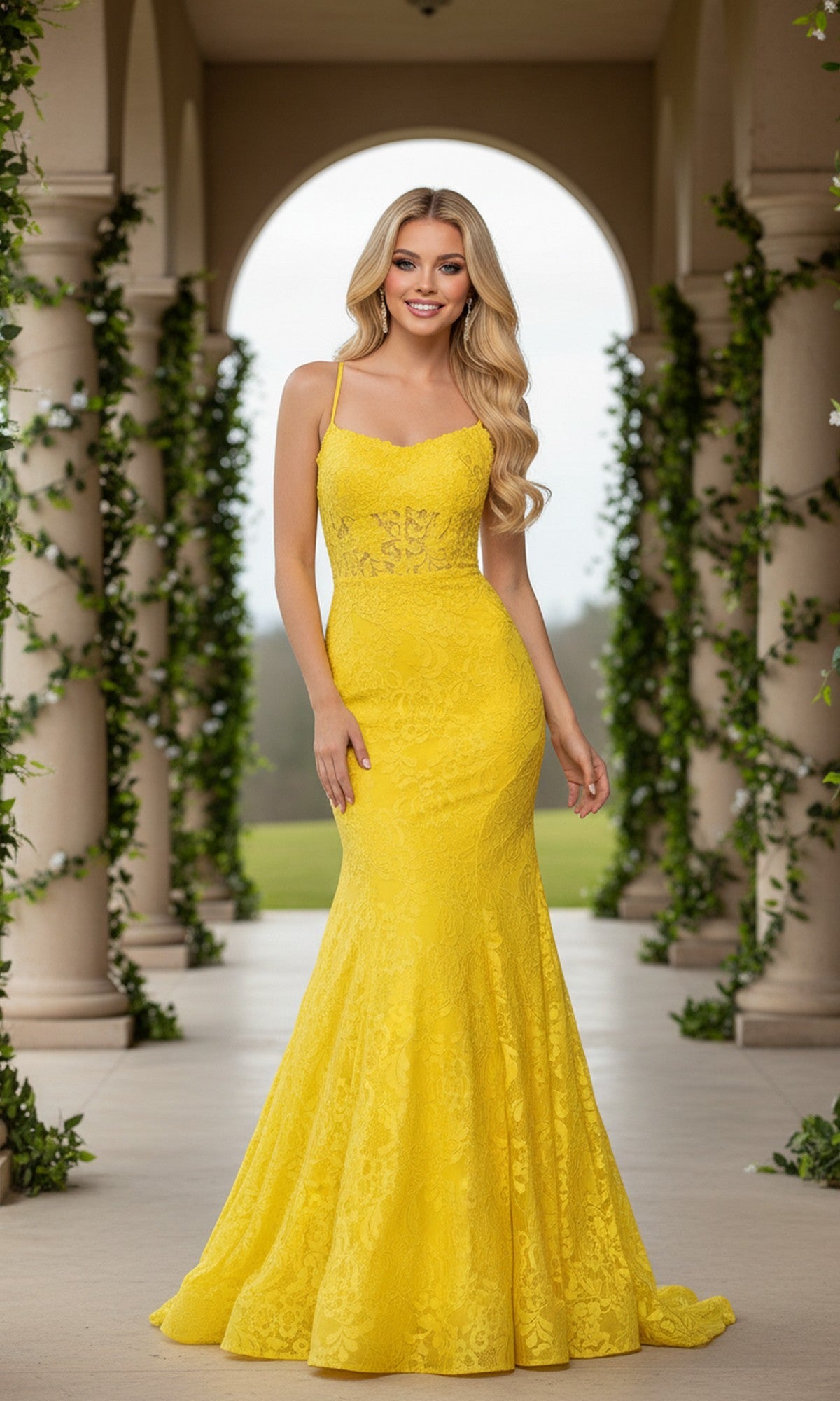 A woman stands outdoors between columns adorned with green vines, wearing the Long Lace Mermaid Prom Dress by La Femme in a vibrant yellow, floor-length style.