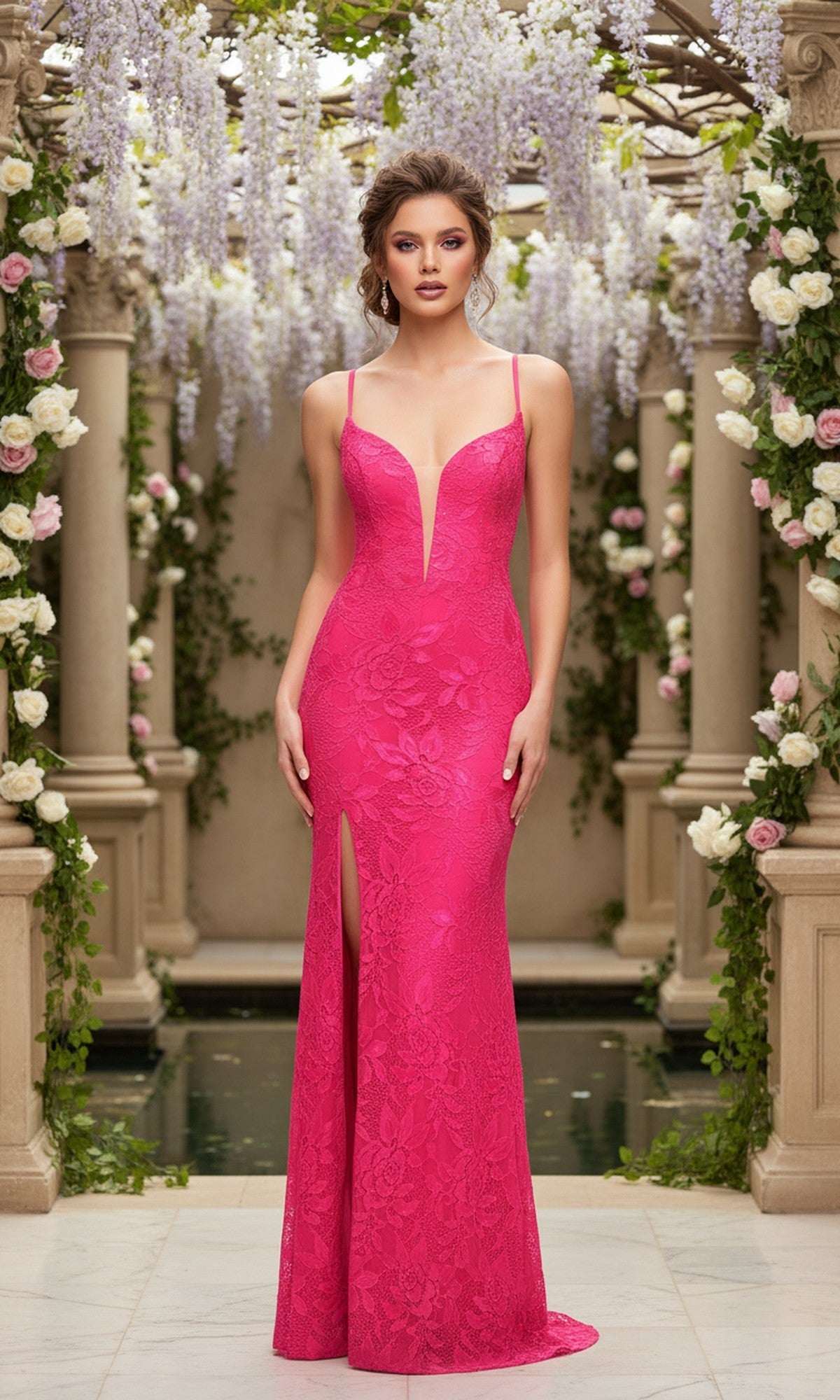 A woman elegantly stands in a flower-filled garden, wearing the Neon Pink Long Lace La Femme Designer Prom Dress featuring a sleeveless design, deep V-neckline, and thigh-high slit.