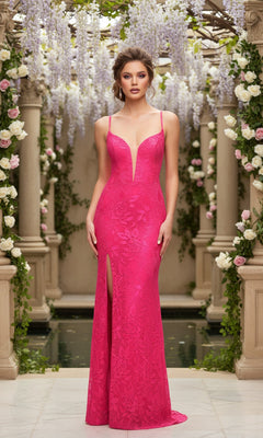 A woman elegantly stands in a flower-filled garden, wearing the Neon Pink Long Lace La Femme Designer Prom Dress featuring a sleeveless design, deep V-neckline, and thigh-high slit.