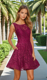 Woman wearing a purple lace dress standing outdoors with palm trees in the background