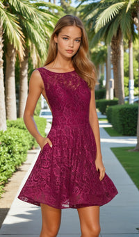 Woman wearing a purple lace dress standing outdoors with palm trees in the background