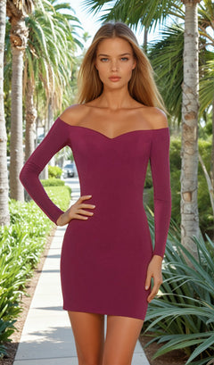 A woman stands on a palm-lined sidewalk wearing the La Femme Off-Shoulder Long Sleeve Hoco Dress 28212.