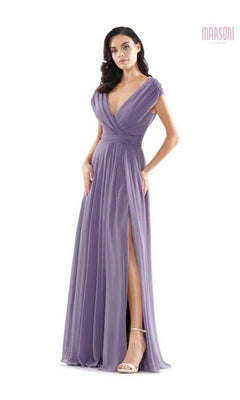 A woman wearing the Marsoni M251 long formal dress in lavender chiffon, featuring a deep V-neckline, cap sleeves, and high leg slit, stands against a white background.