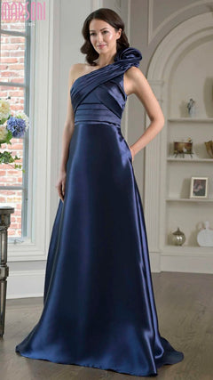 A woman poses indoors in the Marsoni M331 Long Formal Dress—a navy one-shoulder satin gown featuring a floral shoulder accent and a floor-length A-line skirt.