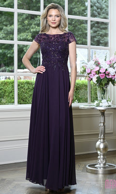 A woman wears a Modest Long Formal Dress: Marsoni M360, a floor-length, eggplant-colored beaded evening gown with cap sleeves and a pleated A-line skirt.