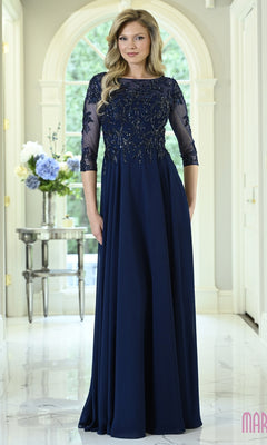 A woman wearing a Modest Formal Dress: Marsoni M361 in navy blue with a beaded bodice and three-quarter-length sheer sleeves.