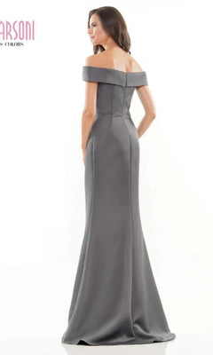 A woman stands with her back to the camera against a plain white background, modeling the Marsoni MV1003 Long Formal Dress, an off-the-shoulder satin evening gown with a fit-and-flare silhouette.