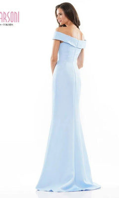 A woman stands slightly turned on a white background wearing the Long Formal Dress: Marsoni MV1003—a light blue, off-the-shoulder satin evening gown with subtle beaded floral embellishments.