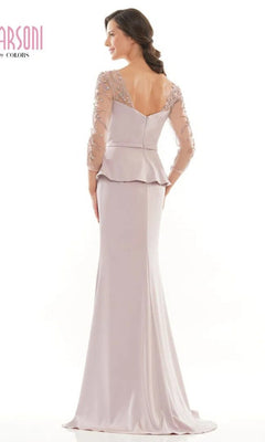 A woman wearing the Marsoni MV1037—a long formal dress in light lavender with sheer beaded sleeves, peplum waist, and V-shaped back—stands facing away.