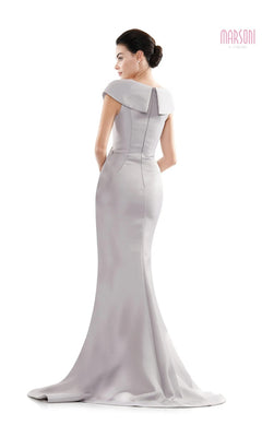 A woman faces away in the Marsoni MV1086: a fitted, floor-length light gray gown with cap sleeves, wide collar, trumpet silhouette, slight train, structured back, and subtle beaded details.