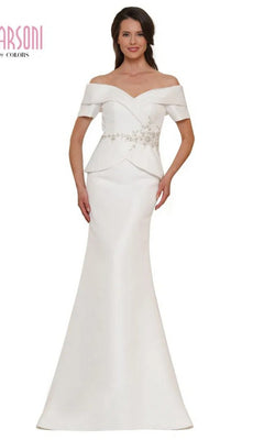 A woman models the Marsoni MV1144 long formal dress in off white, featuring an off-the-shoulder neckline, fitted bodice, beaded peplum detail, floral embellishments, and a flared floor-length skirt for an elegant evening look.