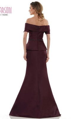 Woman shown from the back wearing the Marsoni MV1144 long formal dress, an off-the-shoulder, floor-length gown in dark burgundy with a fitted waist and flared skirt.