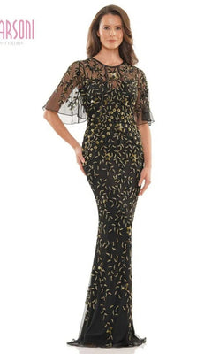 A woman poses against a plain background in the Marsoni MV1208 long formal dress, a black gold gown with a fitted sheath silhouette, sheer short sleeves, and elegant gold embroidered floral patterns.