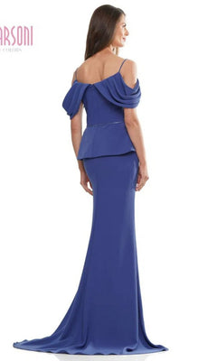Woman in a Marsoni MV1271 long formal dress featuring an off-the-shoulder blue design, fitted stretch crepe bodice, draped sleeves, and floor-length skirt, standing and facing away from the camera.