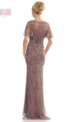 A woman stands with her back to the camera wearing the Marsoni MV1281, a mauve floor-length formal dress featuring short sleeves, lace and sequin details, and an illusion sweetheart neckline.