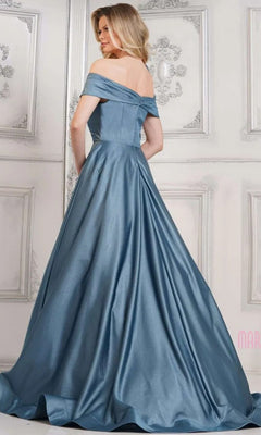 A woman in the Marsoni MV1288 Long Formal Dress faces away from the camera in an ornate room with white wall paneling, highlighting the elegance of her blue satin gown.