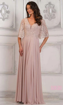 A woman in a mauve Marsoni MV1302 long formal dress with lace bodice and short sleeves stands before an ornate white wall.