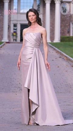A woman in the Marsoni MV1326 long formal dress, a light lavender strapless gown, stands elegantly on a stone driveway before a columned building, embodying timeless sophistication.