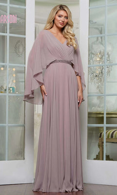 A woman poses indoors in front of glass double doors, wearing the Marsoni MV1350 Long Formal Dress in dusty rose chiffon, featuring flowing sleeves and an embellished waistbelt.