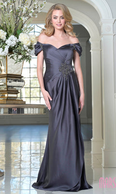 A woman stands indoors wearing the Off-Shoulder Long Formal Dress: Marsoni MV1351 in dark gray satin, featuring waist embellishments—a floor-length, elegant choice for special occasions.