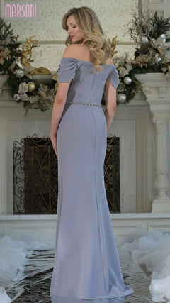 A woman wearing the Marsoni MV1352, a long formal dress featuring an off-shoulder neckline and a beaded waistband.