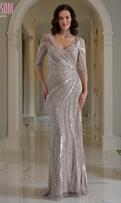 A woman wears a champagne-colored Modest Long Formal Dress: Marsoni MV1380, a sequin evening gown featuring silver beaded diagonal patterns and three-quarter length sleeves.