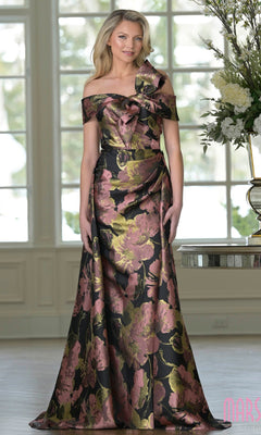 A woman stands indoors near a table with a large flower arrangement, wearing the Marsoni MV1396 long formal dress in Rose Wood Mu.
