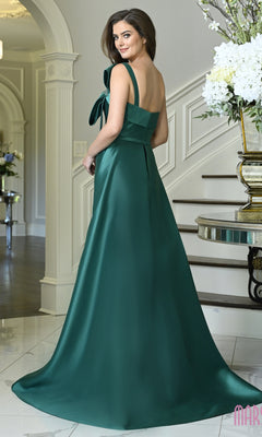A woman wearing an emerald green Long Formal Dress: Marsoni MV1431, featuring a floor-length silhouette and a bow detail on the one-shoulder neckline.