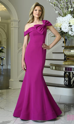A woman wearing a magenta Marsoni MV1432 floor-length, off-the-shoulder crepe evening gown with a bow detail on the neckline.