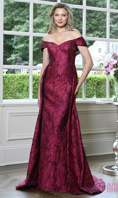 A woman wears a fuchsia Marsoni MV1440 long formal dress featuring an off-the-shoulder neckline, a textured floral jacquard pattern, and a floor-length skirt.