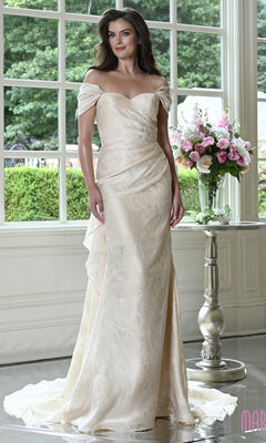 A woman wears a champagne-colored, off-the-shoulder organza jacquard Marsoni MV1441 evening gown featuring a subtle leaf pattern.