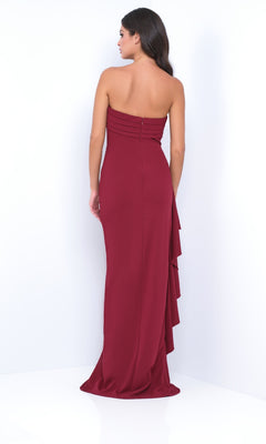Woman in the Strapless Long Ruffle Prom Dress: Velvi Marie—floor-length maroon gown with back ruffle detail—posing against a white background.