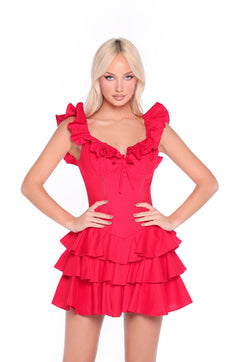 A woman models the Marilyn Ruffled Short Red Casual Party Dress, featuring tiered layers and sleeveless ruffles, standing with hands on hips against a plain white background.