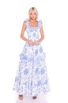 Woman wearing the Mariselle Blue Floral Long Summer Maxi Dress, featuring ruffle details, styled as the ideal summer sundress against a plain white background.