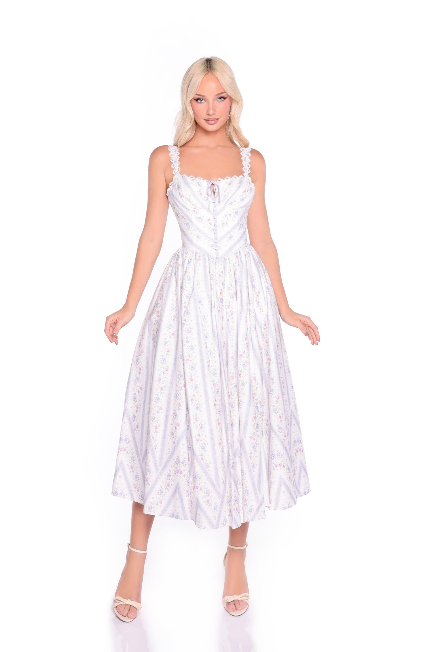 A woman with blonde hair wears the Mirelle Lilac Striped Floral Casual Midi Dress, featuring a fit-and-flare silhouette and ruffled straps, as she stands against a plain white background.