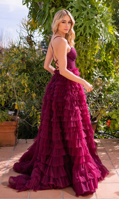 A woman in the Velvi Lace-Corset Long Prom Ball Gown Morgan stands on a tiled patio, surrounded by lush green plants.
