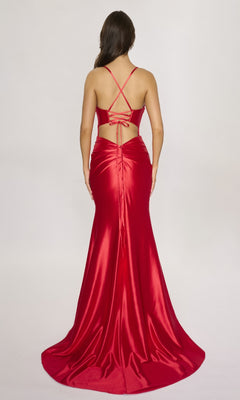 Woman models the Nina Canacci 4435, a floor-length red satin prom dress with a fitted, ruched design, crisscross back straps, and a wrap-style leg slit, elegantly shown from the back.
