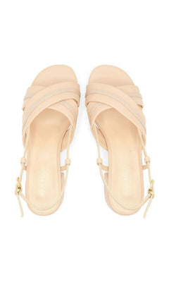 Nancy Nude Prom Shoes: Paradox London P2502 nude shimmer slingback sandals with a low block heel, crisscross toe straps, and adjustable buckle closures.