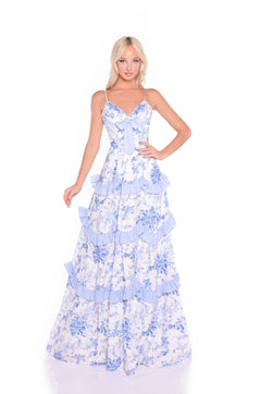 A woman models the Long Blue Floral Casual Maxi Summer Dress: Nina, featuring ruffled tiers and a chest bow, standing against a white background for the perfect casual summer look.