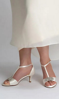 Ophelia White Prom Shoes: Dyeables 4468 white satin kitten heel sandals with a T-strap design and a jeweled embellishment at the toe.