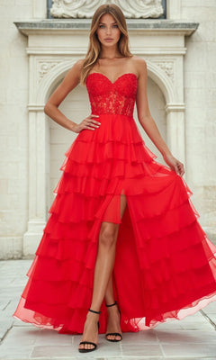 Woman wearing a red tiered a-line floor-length dress with a white architectural background