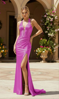 Woman in a magenta evening gown standing in an elegant outdoor setting with flowers and architecture.